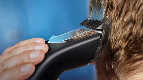 Imagen de machina cortando el pelo