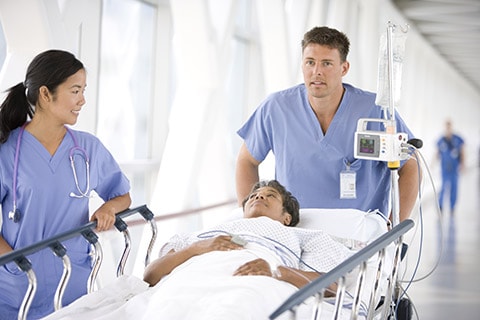 A patient is being wheeled in. Workflow adjustmenst can help  in reducing the risk of HAI
